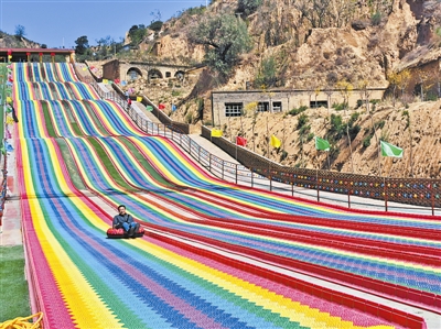 游人乐享彩虹滑道项目。