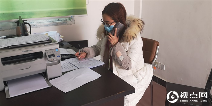 蒋丽蓉在村办公室打电话了解贫困户生产生活状况，宣讲疫情防控知识