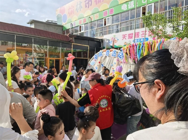 为在场的孩子们逐一发放缤纷气球、甜蜜糖果