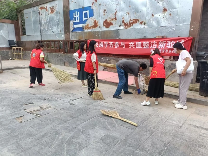 榆阳区鼓楼街道普惠泉社区组织志愿者开展沿街商铺及街巷环境集中整治